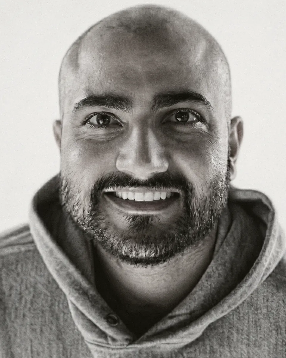 Portrait of Ryan Vafaei against a plain ground, near-monochrome.